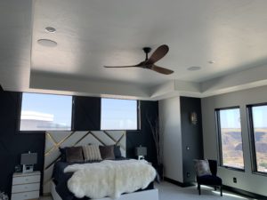bedroom with custom installed ceiling fan and lighting.